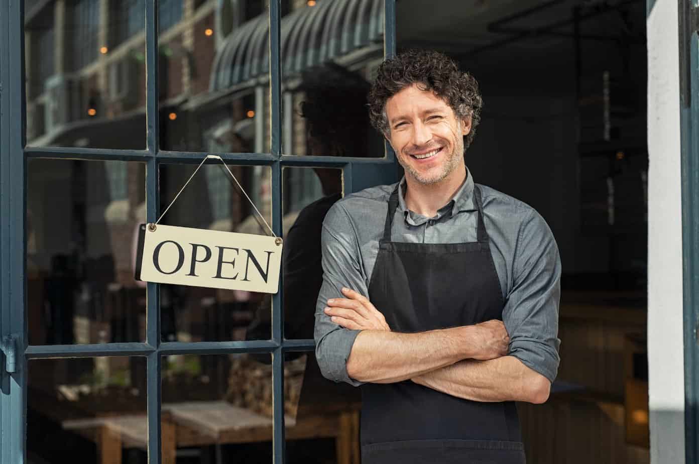 Owner standing outside restaurant