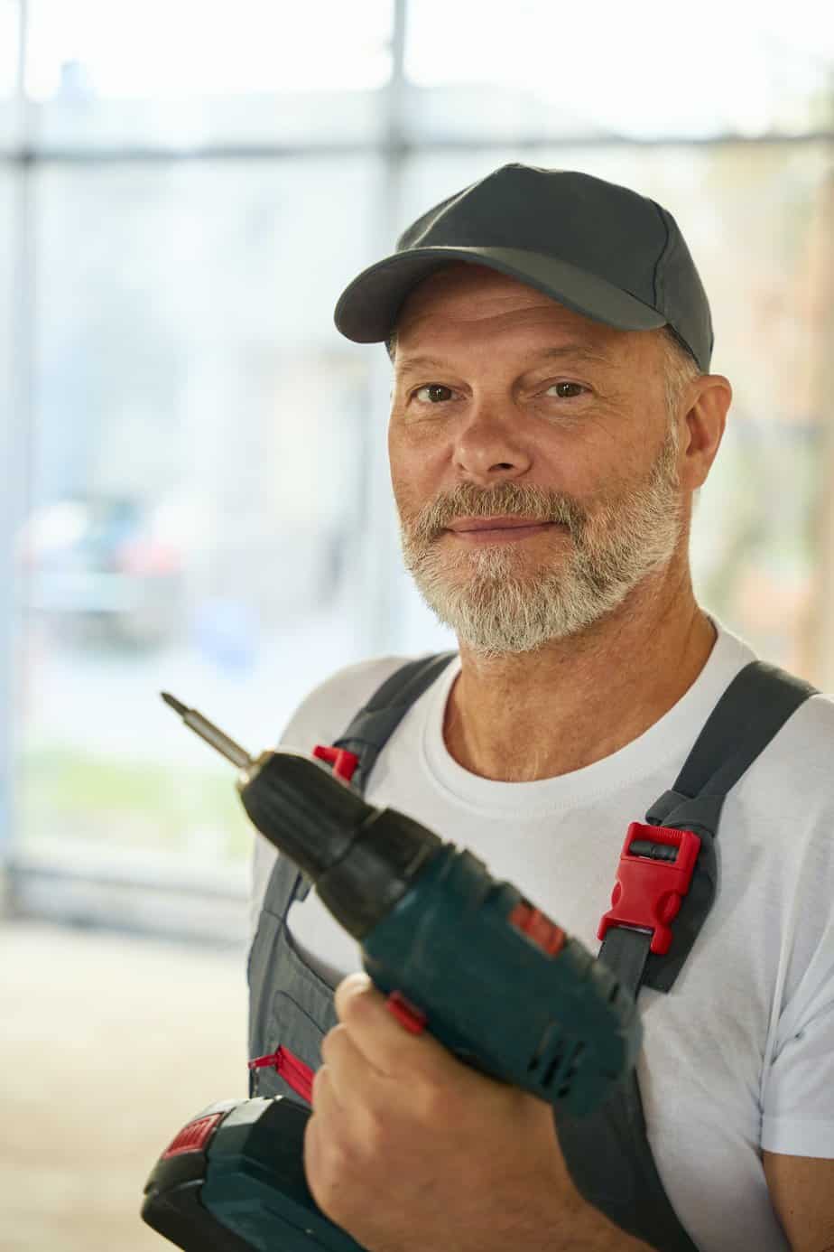 Marketing For Locks & Locksmiths Portrait of bearded builder with drill in his hands